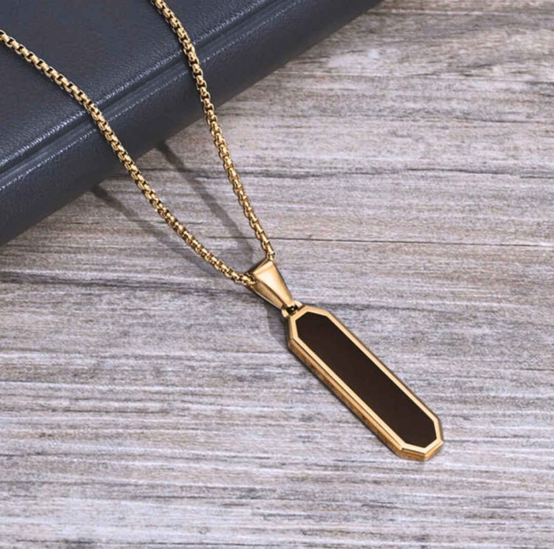 Discover elegance with our 18k gold-plated pendant featuring a striking black stainless steel center. A perfect accessory to add a touch of luxury to any outfit.