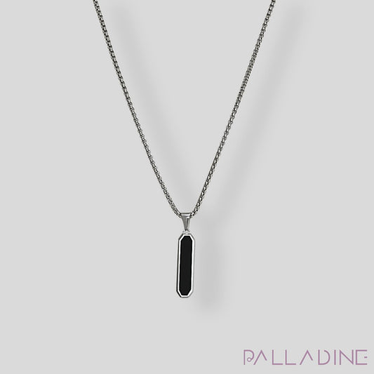 Discover elegance with our Rhodium-plated pendant featuring a striking black stainless steel center. A perfect accessory to add a touch of luxury to any outfit.